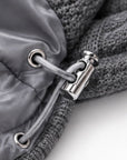 Close-up of the adjustable drawstring hem with metal toggle on the grey cashmere cable knit down vest