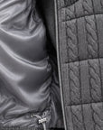 Inside of grey cashmere cable knit down vest showing the silky grey lining and drawstring hem