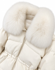 Close-up of the voluminous fox fur hood trim and drawstring waist on the winter white down puffer jacket – Dolcie London